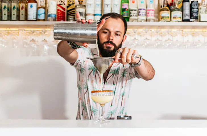 A bartender pours a drink at Calita. 