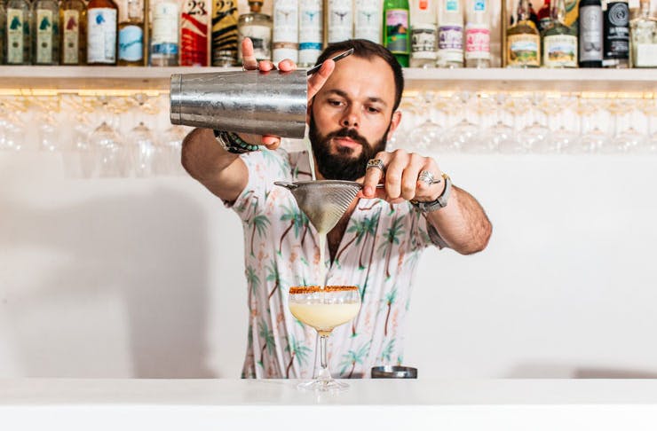 A bartender pours a drink at Calita. 