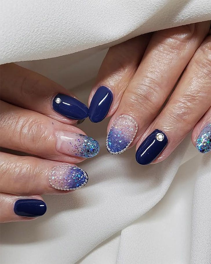 Bejewelled nails peek out at Calla Nail, one of the best nail salons in Auckland.