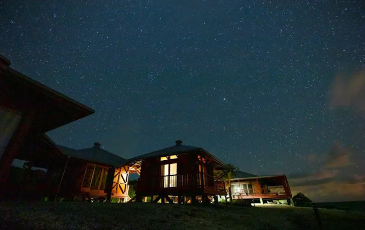 several small cabins under a starry sky