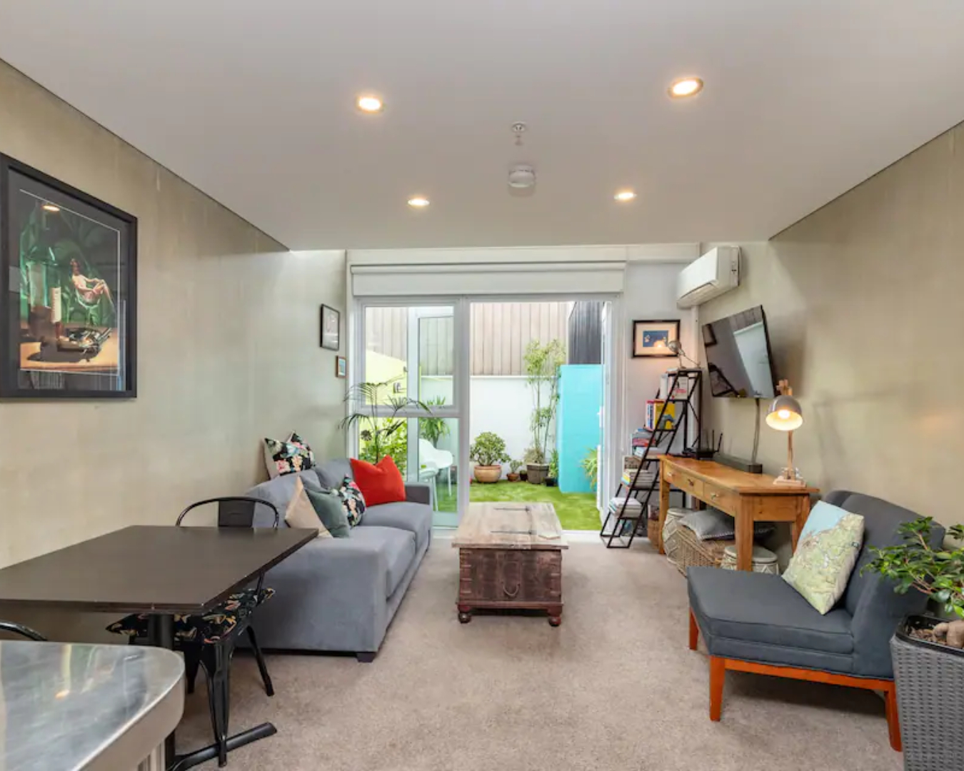 The living area in the Canvas Apartment leads to a light-filled, private courtyard and is one of the best airbnbs in Wellington.