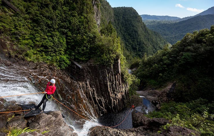 A girl hanging over a deep canyon