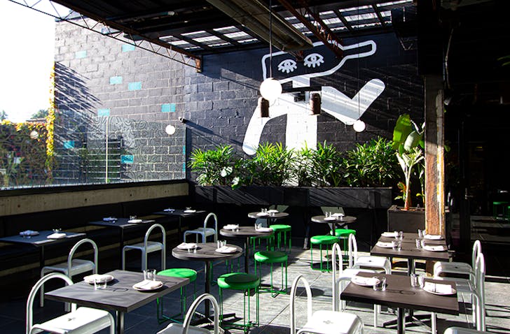 Several tables in a courtyard.