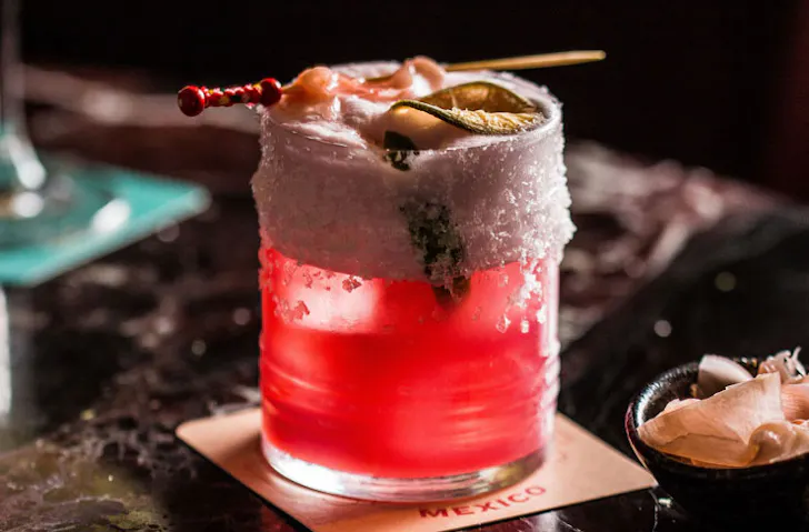 A bright pink cocktail. 
