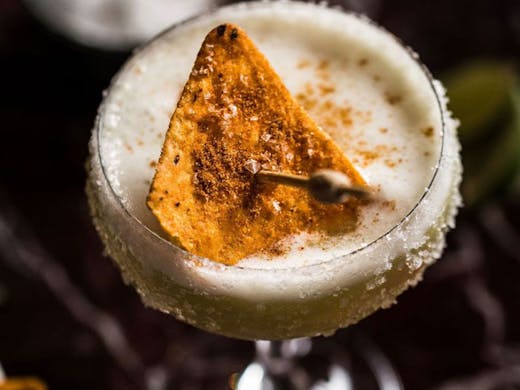 A margarita with a corn chip float. 