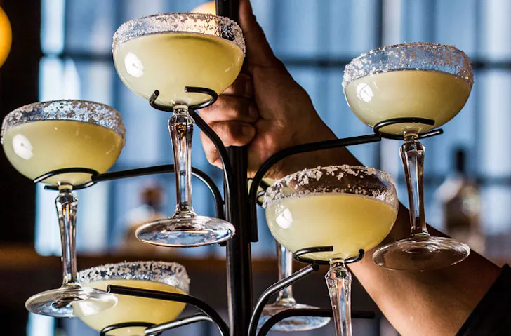 A tree-like stand filled with margarita cocktails. 