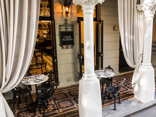Grand columns and draped white curtains at the entrance to Casa Merida bar in Potts Point. 