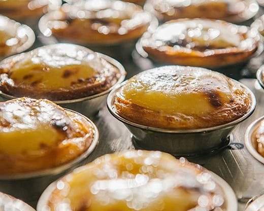 Freshly baked Portuguese tarts in the oven from Casa Nata.