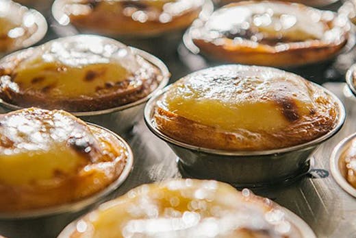 Freshly baked Portuguese tarts in the oven from Casa Nata.