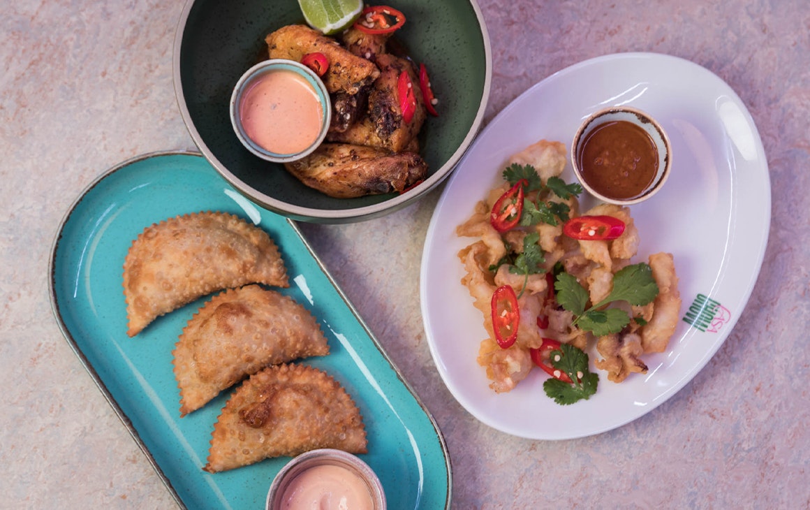 plates of empanadas, wings and ceviche