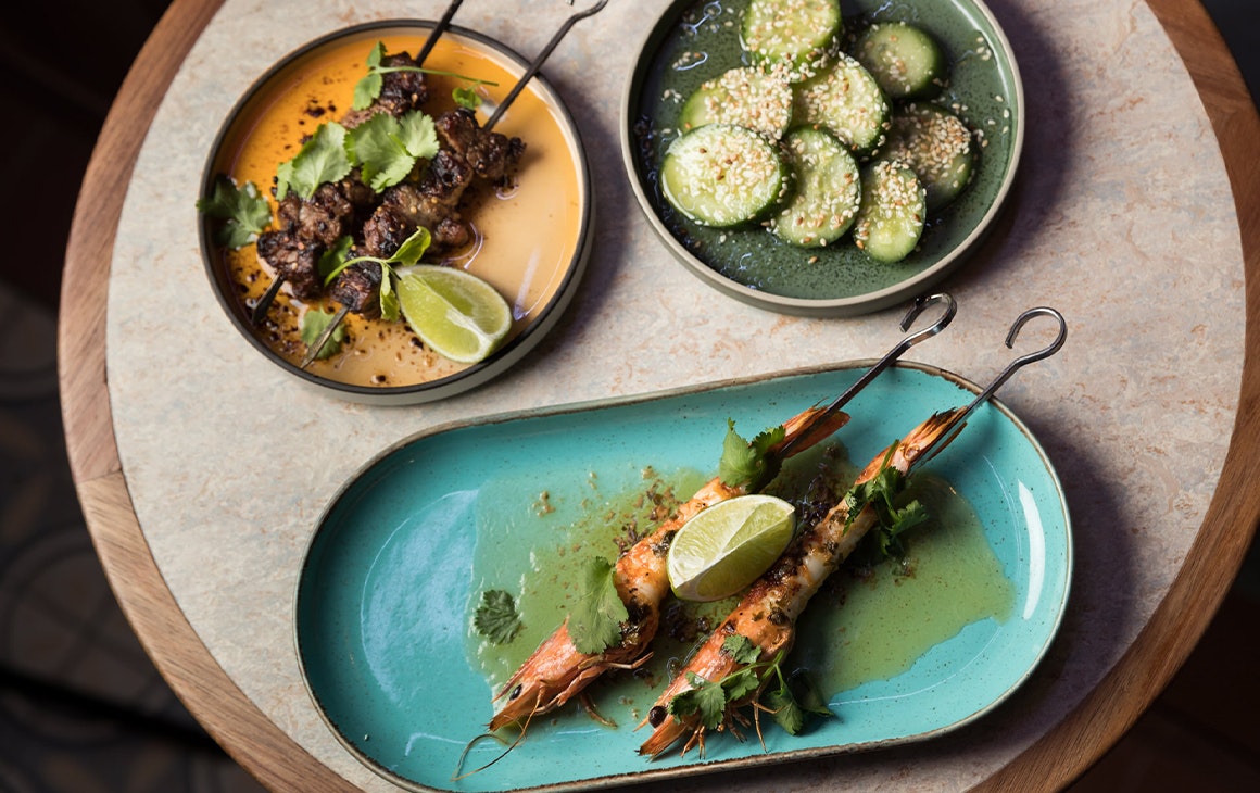 plates of skewers and pickled cucumber