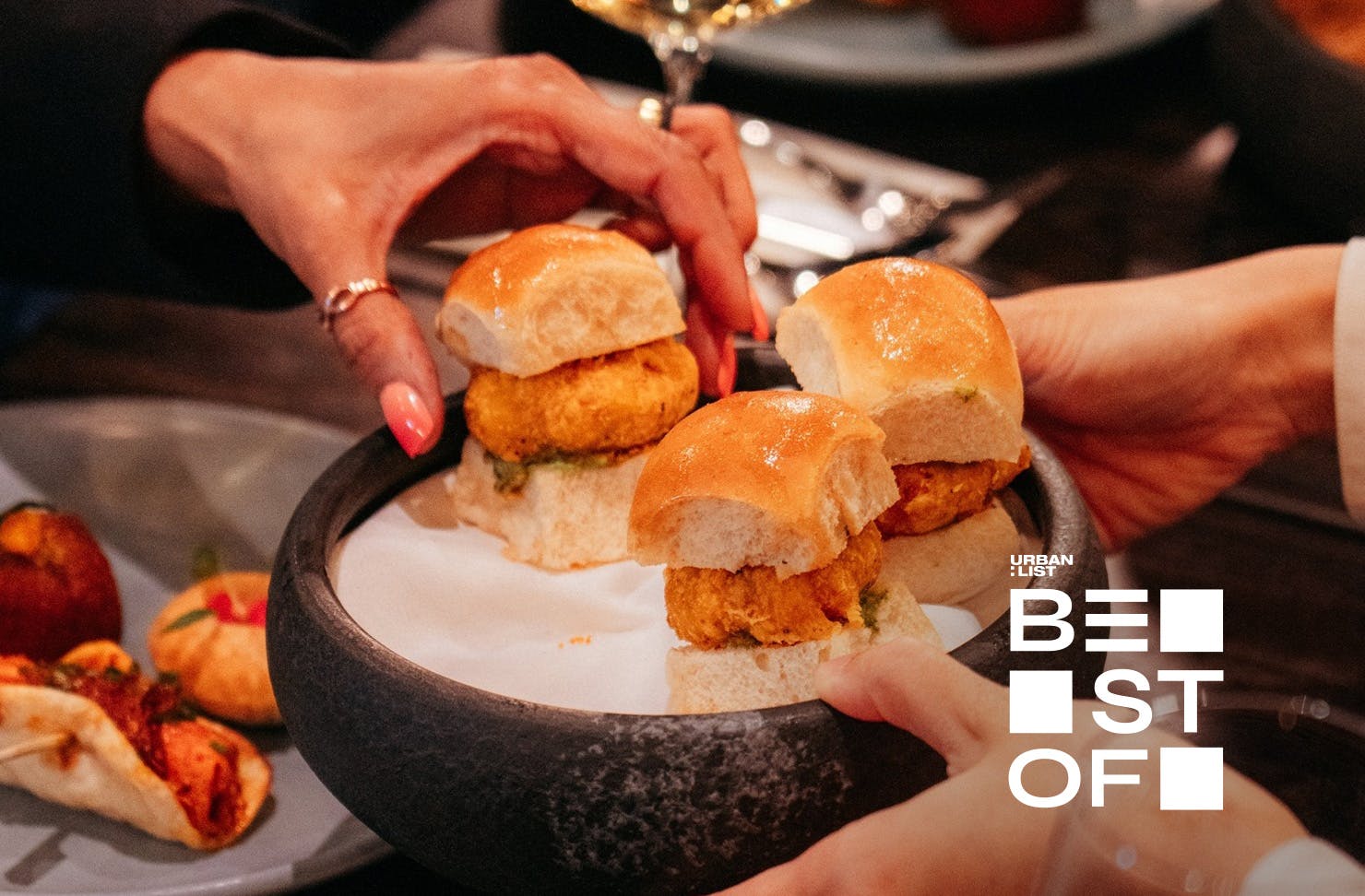 Someone grabs a delicious snack at Cassia, one of the best Indian restaurants in Auckland.