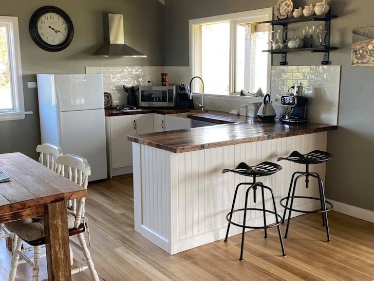 A cosy kitchen with blonde and white timber.