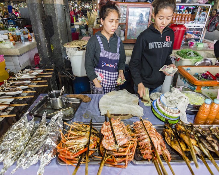 women at market stall 