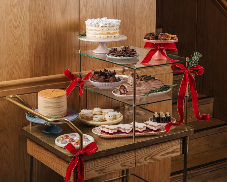 A decadent dessert trolley decorated with bows for Christmas at The Charles