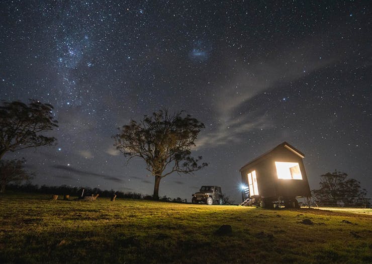 the tiny house under a starry night sky