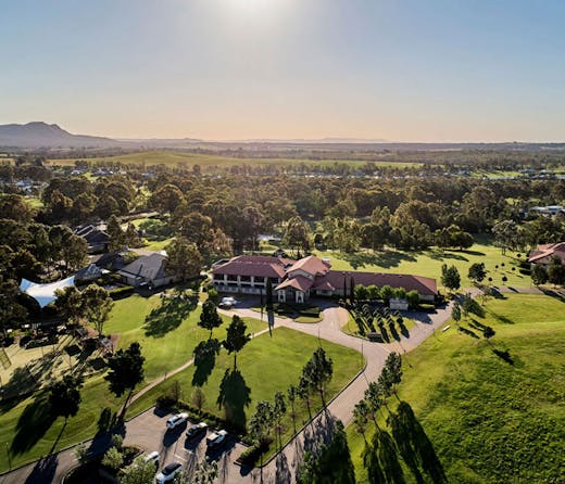 An aerial view of the Chateau Elan resort in the Hunter Valley, surrounded by vineyards and its golf course.  