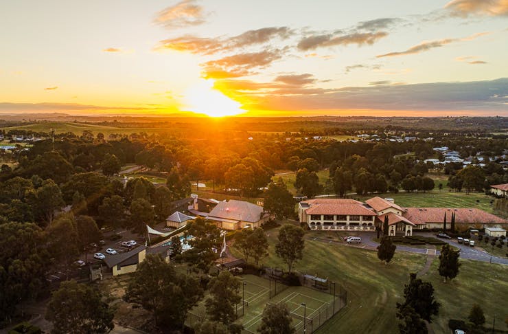 An aerial view of the Chateau Elan Hunter Valley resort at sunset. 