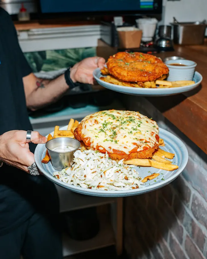 Two hulking great plates of chicken parma at Dr Rudi's.