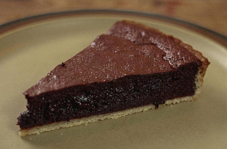 a slice of gooey chocolate tart