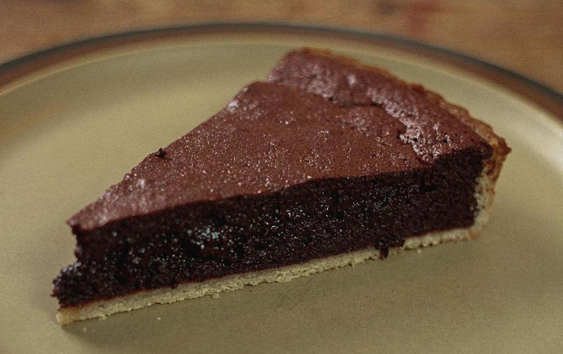a slice of gooey chocolate tart