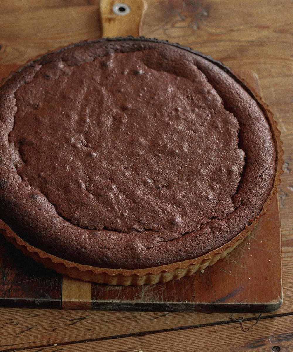 a chocolate tart on a chopping board