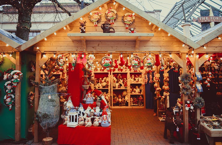 a christmas market stall filled with christmas toys and ornaments
