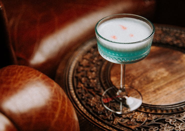 a blue cocktail on a table