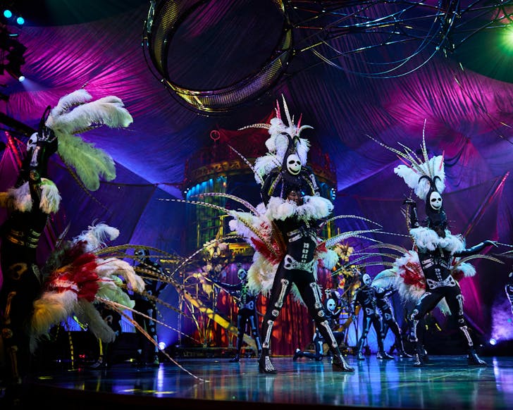 cirq du soleil dancers dressed in elaborate costume perform on stage