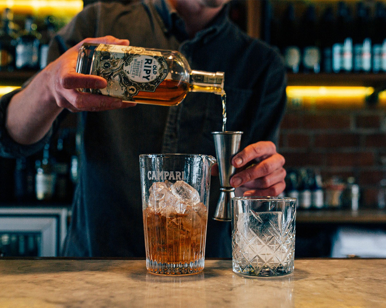 A man pours an old fashioned at Civil & Naval, one of the best bars in Christchurch.