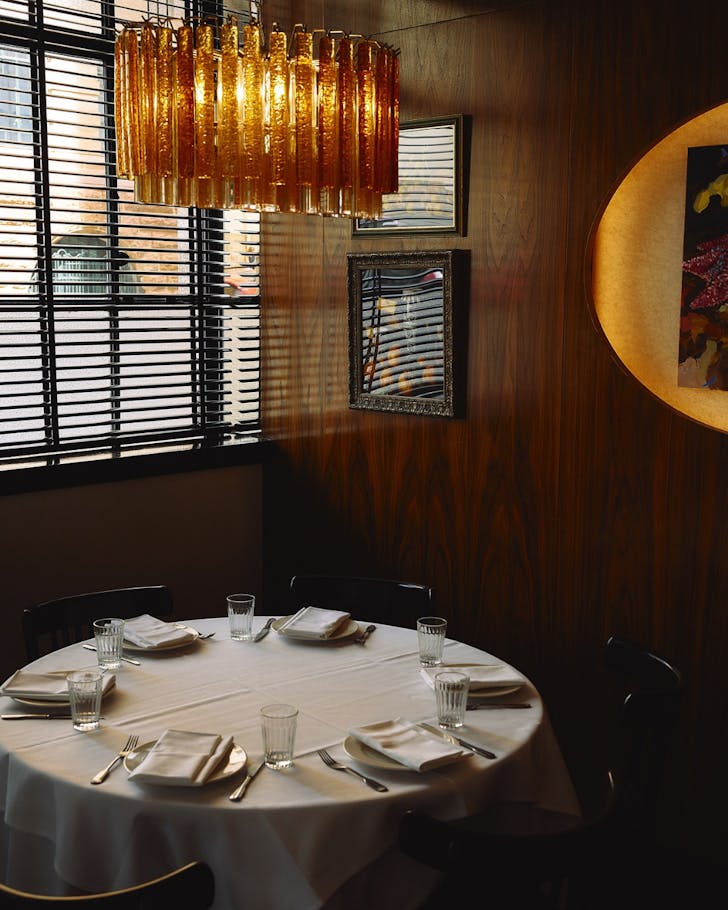 A mood-lit round window seat at Clam Bar in Circular Quay