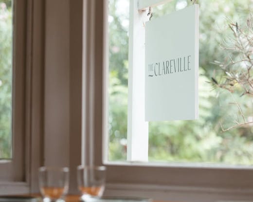 The Clareville sign shot through a window