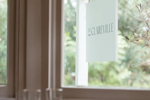 The Clareville sign shot through a window