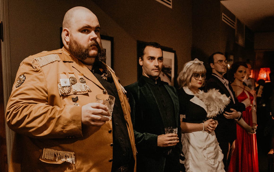a row of people dressed as cluedo characters