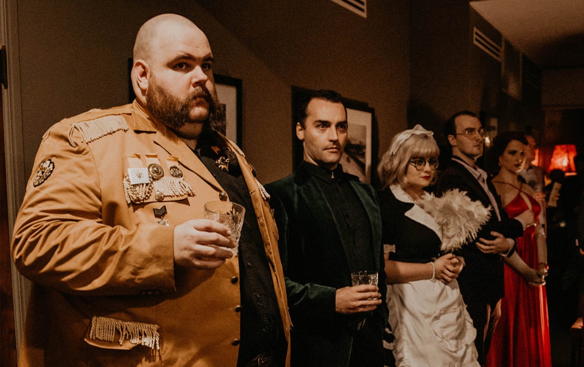 a row of people dressed as cluedo characters