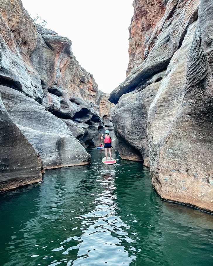 a person on a SUP in a stunning gorge