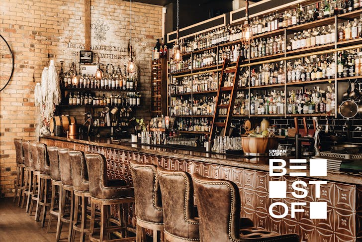 a bar line with shelves of spirits at brisbane cocktail bar cobbler