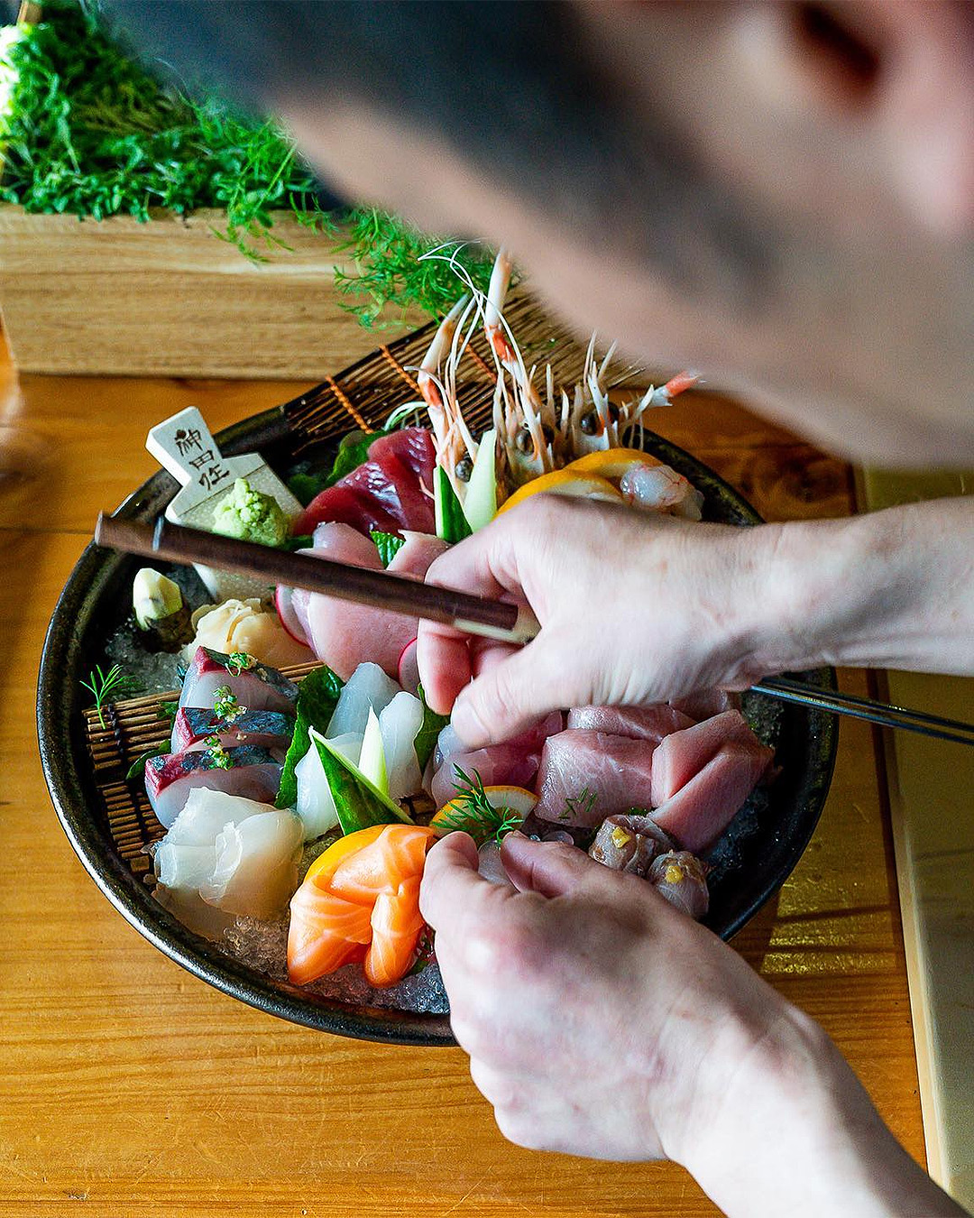 Makoto puts the finishing touches on a huge sashimi platter at Cocoro.