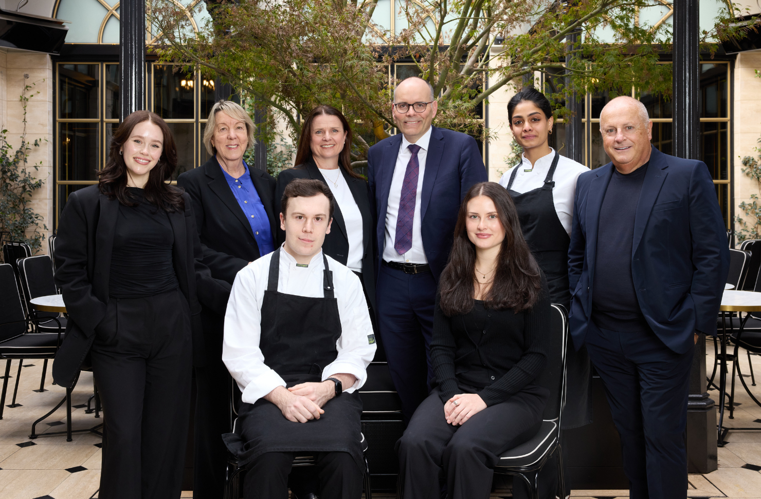 The collective foundation staff members sit for a portrait
