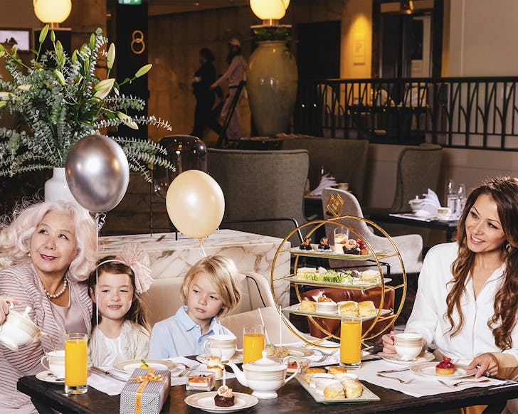 Two mums sit down with kids on mothers day at the Cordis