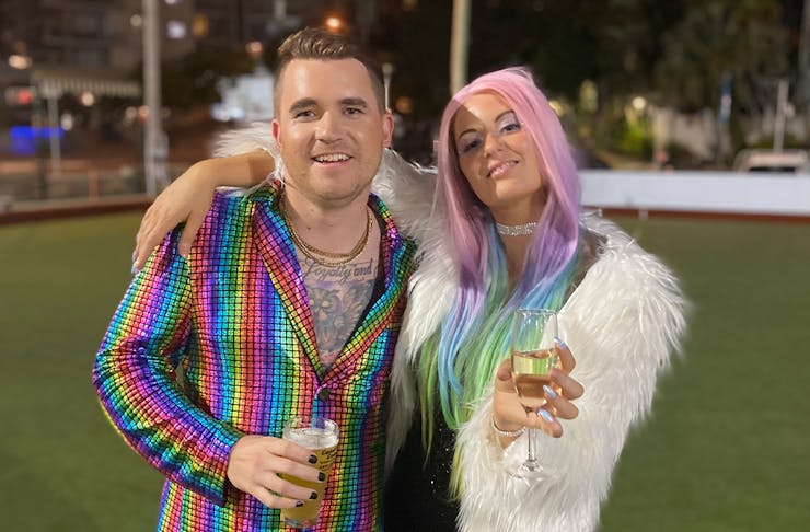 two people dressed up in rainbow coloured costumes for Mardi Gras