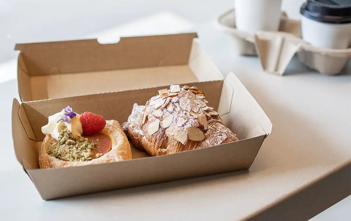 two pastries in a takeaway box 