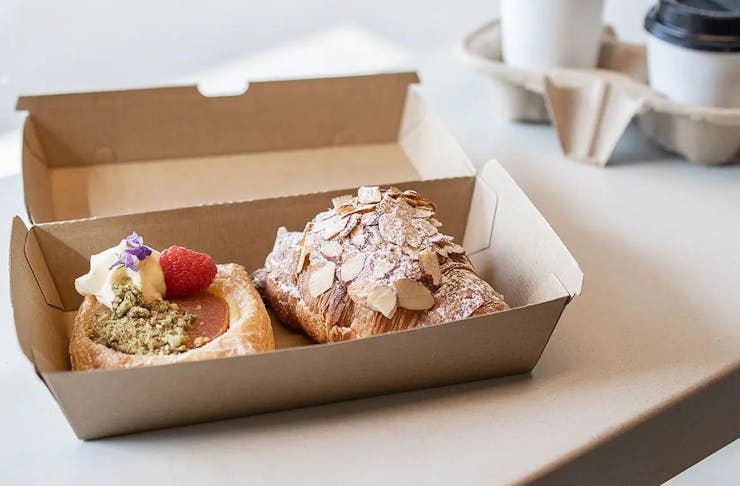 two pastries in a takeaway box 