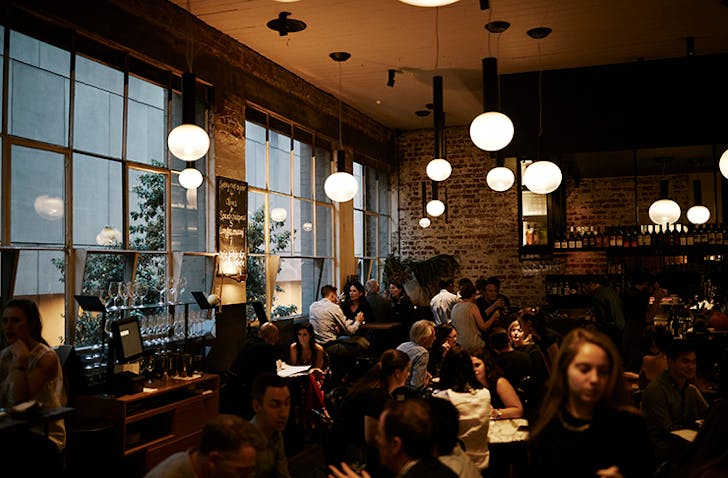 A busy restaurant with people dining at tables. 