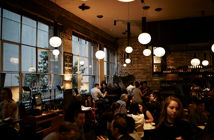 A busy restaurant with people dining at tables. 