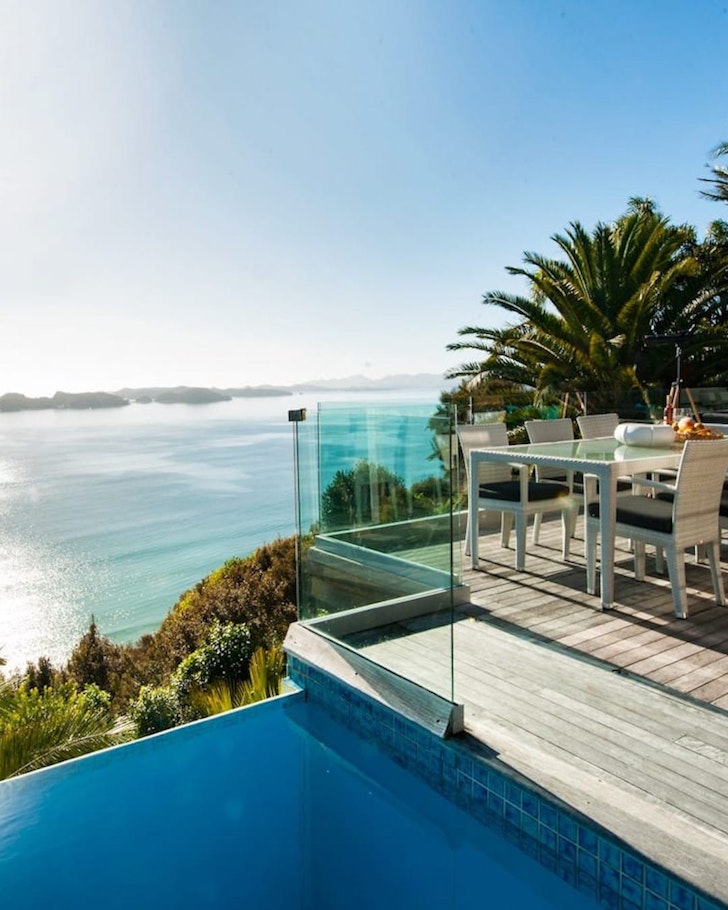 A view of the pool overlooking the ocean at Cloud 9 one of the best NZ Airbnbs