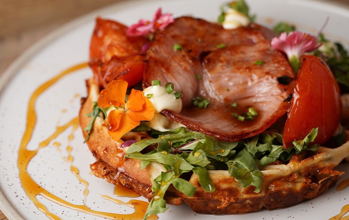 a savoury waffle topped with bacon