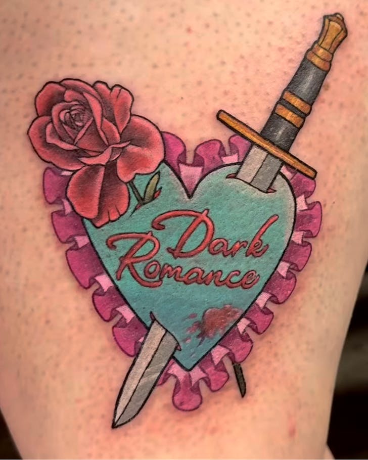 A retro tattoo with a sword and rose through a heart bearing the words 'Dark Romance'.