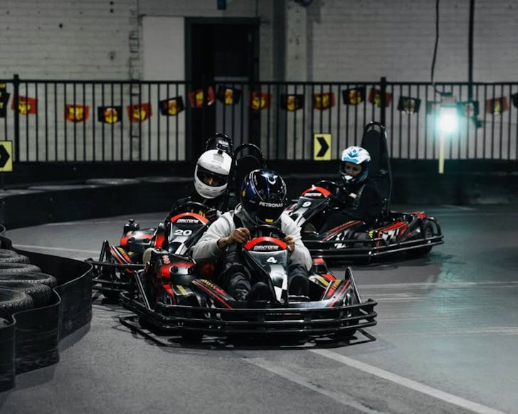 a go-kart race commences with three drivers at daytona adventure park