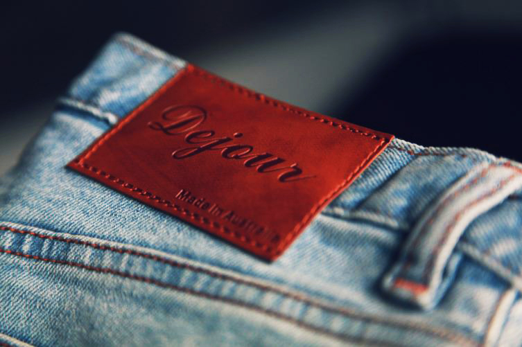 A pair of jeans with the words 'Dejour' on it, one of the best things to do in Brunswick